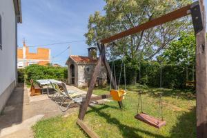 a swing set in the yard of a house at Perinic, No 2 in Vrsi