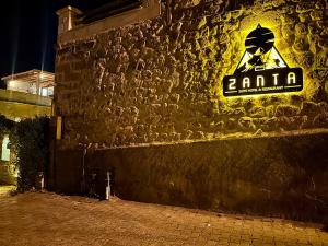 Zanta Suite Hotel في أوروغوب: علامة نيون على جانب المبنى