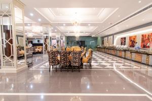 a restaurant with a table and chairs in a mall at Hotel Miracle Resort in Phagwāra