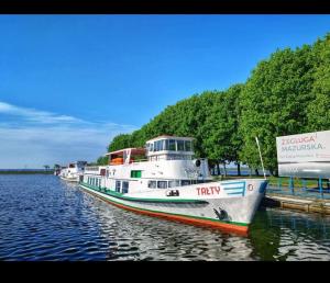 two boats are docked at a dock in the water at Mieszkanie w Giżycku in Giżycko