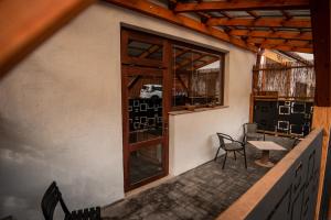 a balcony with chairs and a table and a window at APART Mikeš in Telč