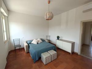 a bedroom with a bed and a table and a chair at A due passi dai Miracoli in Pisa