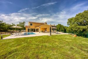 a house with a pool and a yard at Villa AnaLucija in Labin