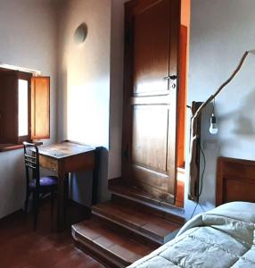 ウルビーノにあるカントリー ハウス カ ヴェルナッチァのベッドルーム1室(デスク、ベッド1台、デスク、窓付)