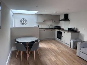 a kitchen with a table and chairs in a room at The Greenhouse in Wick