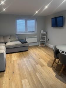 a living room with a couch and a table at The Greenhouse in Wick +20 photos