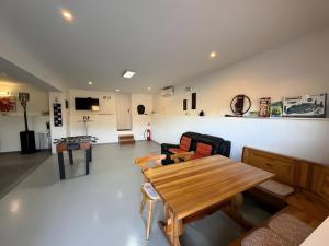 a living room with a wooden table and chairs at Apartment Ana with a Charming Jacuzzi near Marija Bistrica in Veliki Komor +8 photos