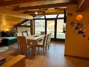 a dining room with a table and chairs at Apartment Ana with a Charming Jacuzzi near Marija Bistrica in Veliki Komor