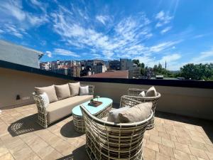 a patio with a couch and chairs on a balcony at Weingart Suites Hotel in Istanbul +37 photos
