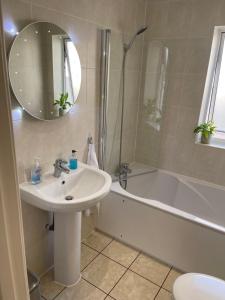 a bathroom with a sink and a shower and a tub at Redcliffe View - Shared Homestay with Resident Show Dogs in Portishead