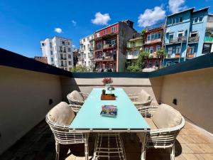a table and chairs on a balcony with buildings at W Suites Istanbul in Istanbul