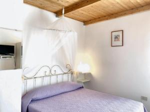een slaapkamer met een bed in een witte kamer bij 2 bedrooms apartement with terrace at Galtelli in Galtellì