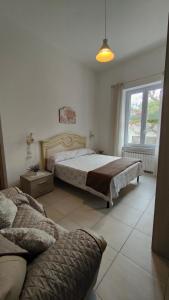 a bedroom with a large bed and a window at Casa Rinuccia in Ischia