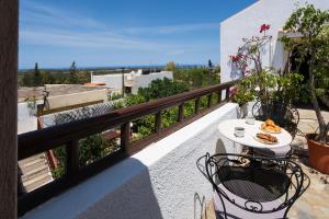a balcony with a table and chairs on a balcony at Ilianthos Traditional Maisonette in Hersonissos