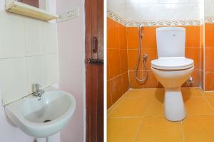 a bathroom with a toilet and a sink at FabHotel Terra in Chennai