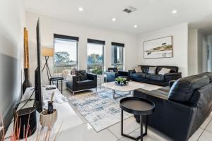 a living room with couches and a tv at Enfield Executive in Gepps Cross