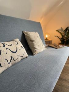 a blue bed with two pillows on top of it at Casa Marcu Wohnung 1 OG in Landkirchen