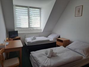 Postel nebo postele na pokoji v ubytování Penzion Škubánek