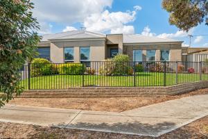 a house with a black fence and stairs at Enfield Executive in Gepps Cross
