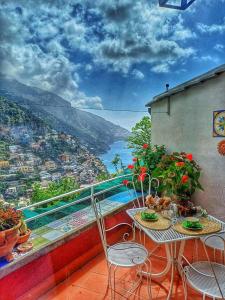 a balcony with a table and chairs with a view at Casa Danira - Positano in Positano