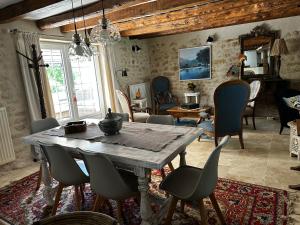 a dining room with a wooden table and chairs at Le Vallonnet Gîte classé 5 étoiles in Le Vigan