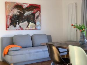 a living room with a couch and a table with a painting at Casa Marcu Wohnung 2 EG in Landkirchen