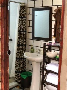 a bathroom with a sink and a mirror at Mashambani Cottages in Nyahururu