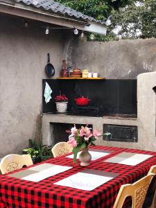 a table with a red and black checkered table cloth at Mashambani Cottages in Nyahururu