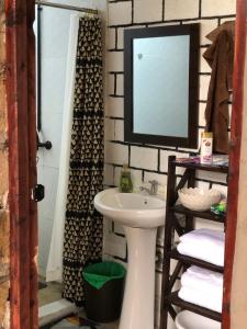 a bathroom with a sink and a mirror at Mashambani Cottages in Nyahururu