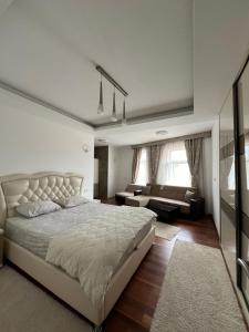 a bedroom with a large bed and a couch at Diamond Hotel & Restaurant in Ulcinj