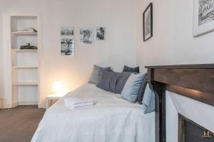 a bedroom with a bed and a fireplace at Montmartre Apartments - Degas in Paris