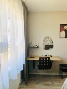 einen Schreibtisch und einen Stuhl in einem Zimmer mit Fenster in der Unterkunft Arena Hotell in Vänersborg