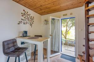 a room with a table and chairs and a patio at Apartments Marija 1000 in Rabac