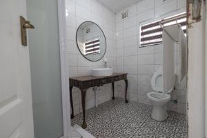 a bathroom with a sink and a toilet at Safi Classic 3 bedroom Apartment 4 in East London