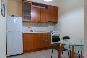 a kitchen with a white refrigerator and a table at Katrina House in Rethymno Town