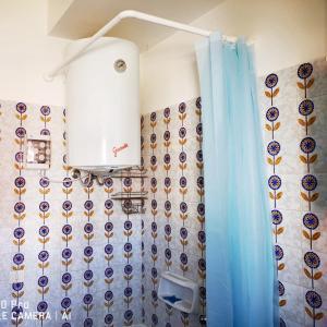 a bathroom with a shower with a blue shower curtain at 2 bedrooms apartement at Porto Recanati 200 m away from the beach with furnished terrace in Porto Recanati