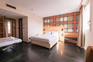 a hotel room with a bed and a bed and a window at easyHotel Nice Old Town in Nice +55 photos