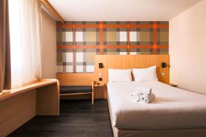 a hotel room with a bed and a window at easyHotel Nice Palais des Congrès – Old Town in Nice
