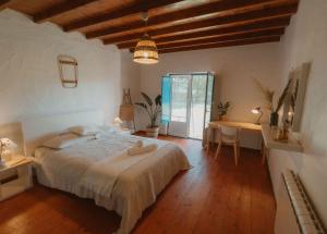 a bedroom with a large bed and a table and chairs at NaNa House Ericeira - Yoga & Surf in Santo Isidoro +93 photos