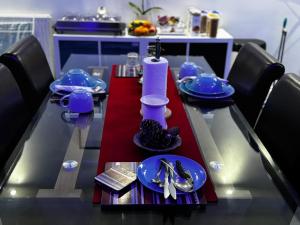 a dining table with blue dishes on it at KAYUMBA Properties LTD in Leeds +54 photos