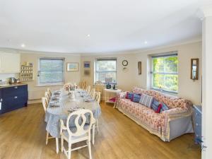 a living room with a couch and a table and chairs at 16 Solent Landing in Bembridge