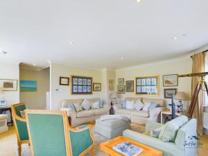a living room with two couches and a table at 16 Solent Landing in Bembridge
