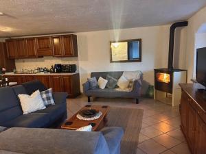 a living room with a couch and a stove at Stefano Alps Apartment in Saint Nicolas