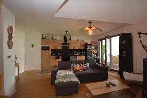 a living room with a couch and a table at Appartement Duplex équipé 12 mn saint Lazare et 15mn stade de France in Colombes