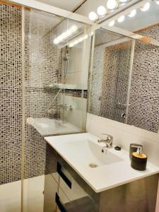 a bathroom with a sink and a shower and a mirror at One bedroom apartement with city view enclosed garden and wifi at Granada in Granada