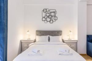 a bedroom with a white bed with two lamps at Alpin Clabucet Studio in Predeal