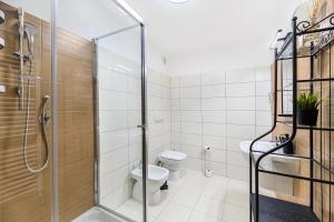 a bathroom with a toilet and a glass shower at Alpin Clabucet Studio in Predeal +19 photos