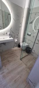 a bathroom with a sink and a toilet and a mirror at Kiani Akti in Porto Rafti