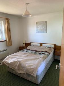 a bedroom with a large bed in a room at Alba, Beach Front Close to Restaurant in Lamlash