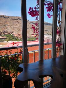 a table in front of a window with a view at Puerto de Mogan Sonneland in Puerto de Mogán